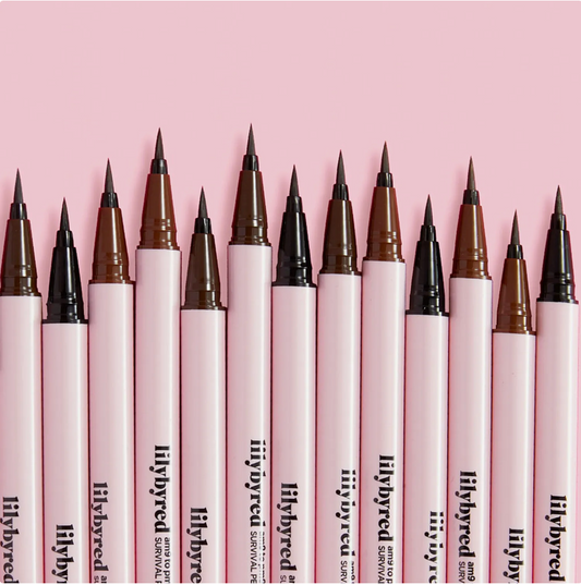 Row of lilybyred survival pens with various tip colors on a pink background