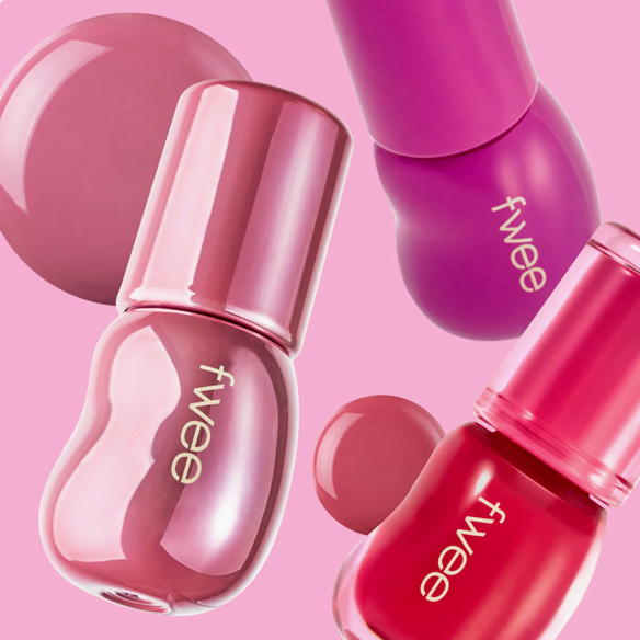 Pink nail polish bottles with 'fwee' branding on a pink background