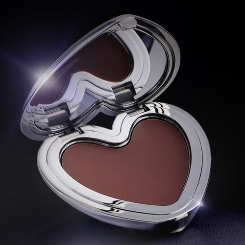Heart-shaped makeup compact with brown blush on a black background