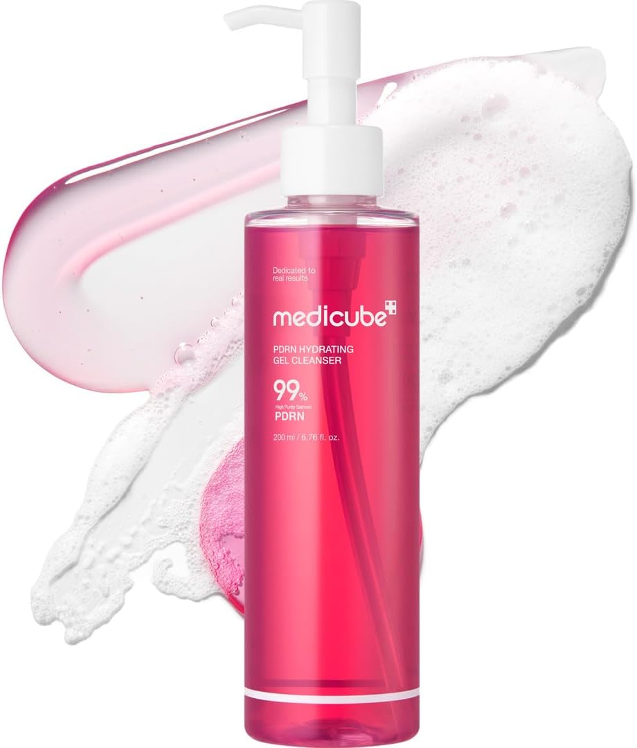Pink bottle of Medicube skin care product with foam on a white background