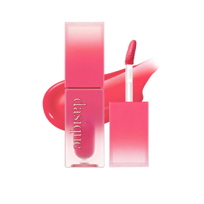 Pink lip gloss with applicator and packaging on a white background