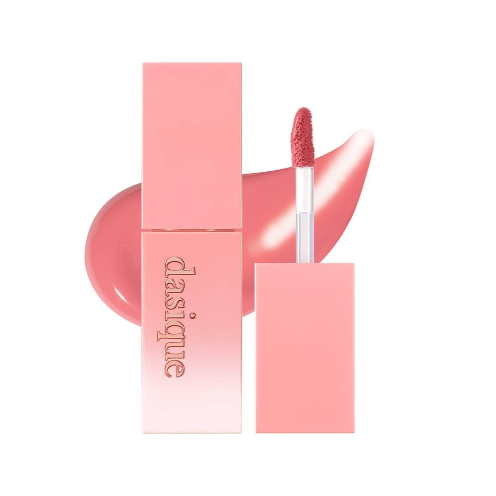 Pink lipstick with applicator and packaging on a white background