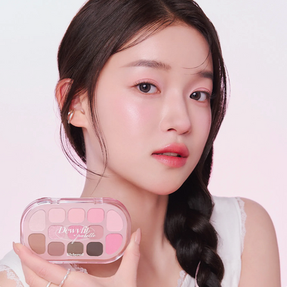 Woman holding a makeup palette with a plain background. Lilybyred Dewy Fit Palette for Korean eye makeup, available at LKR