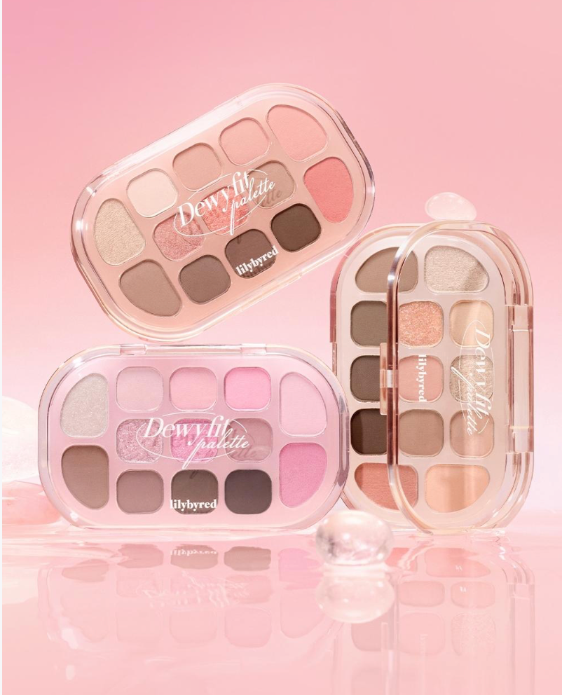 Three makeup palettes with 'Dewy' text on a pink background. Lilybyred Dewy Fit Palette eyeshadow palette for Korean makeup