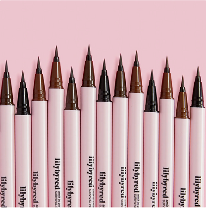 Row of lilybyred survival pens with various tip colors on a pink background