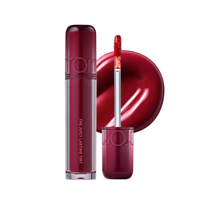 plum color Lip tint with applicator and packaging on a white background