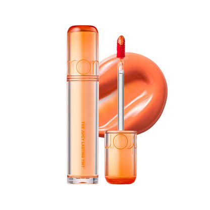 Orange lip gloss with applicator on a white background